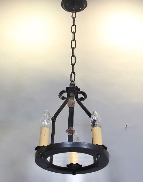 Vintage wrought iron chandelier with candles.