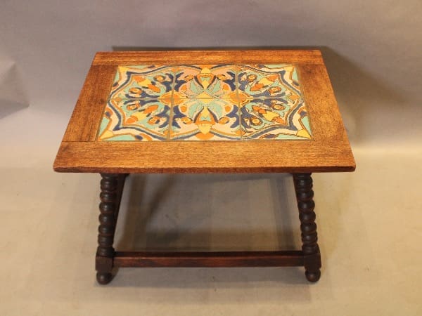 Wooden table with colorful tiled top.