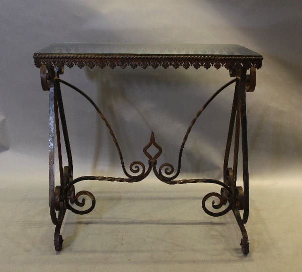 Ornate wrought iron table with intricate design.