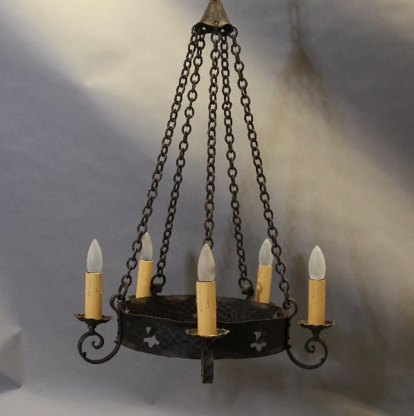 Vintage wrought iron chandelier with candles.