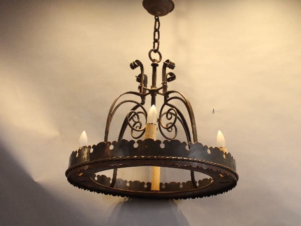 Vintage wrought iron chandelier with candles.