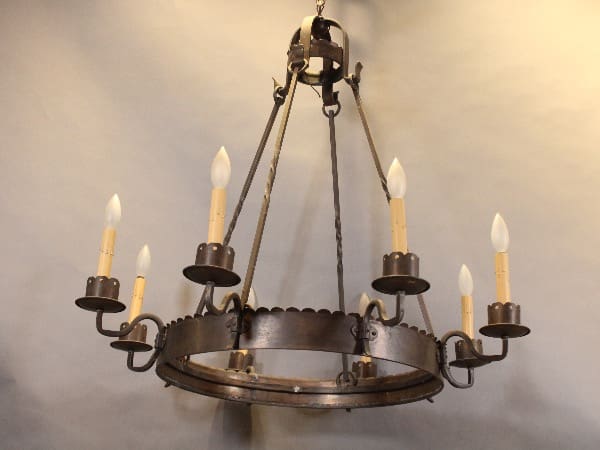 Rustic metal chandelier with candle-like bulbs.