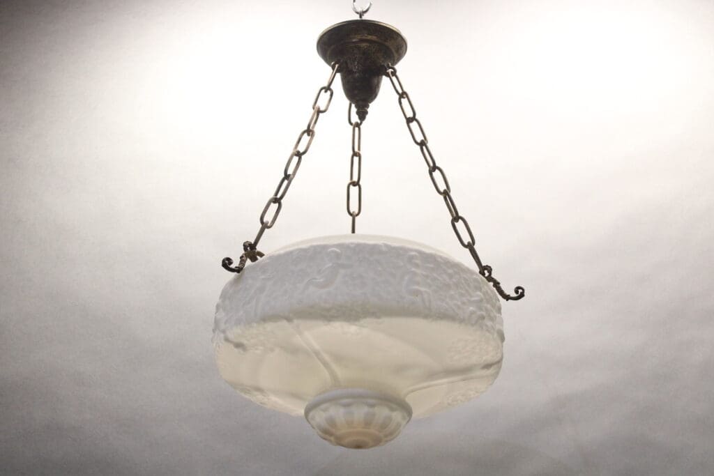 Vintage hanging lamp with chain and frosted glass.