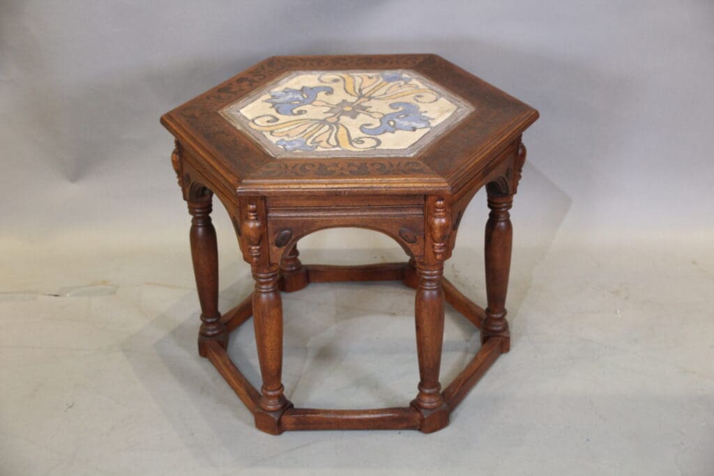 Hexagonal wooden table with decorative top.