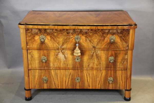 Antique wooden dresser with ornate handles.