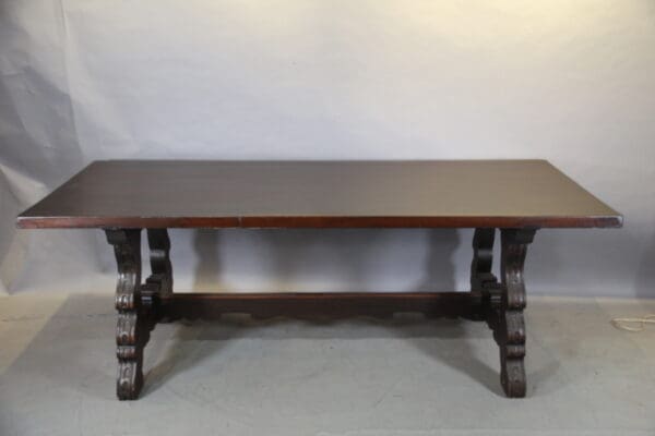 Wooden table with ornate carved legs.