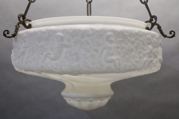 Decorative frosted glass chandelier with ornate details.