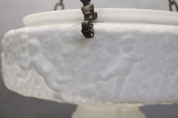 Ornate white ceiling light with cherub design.