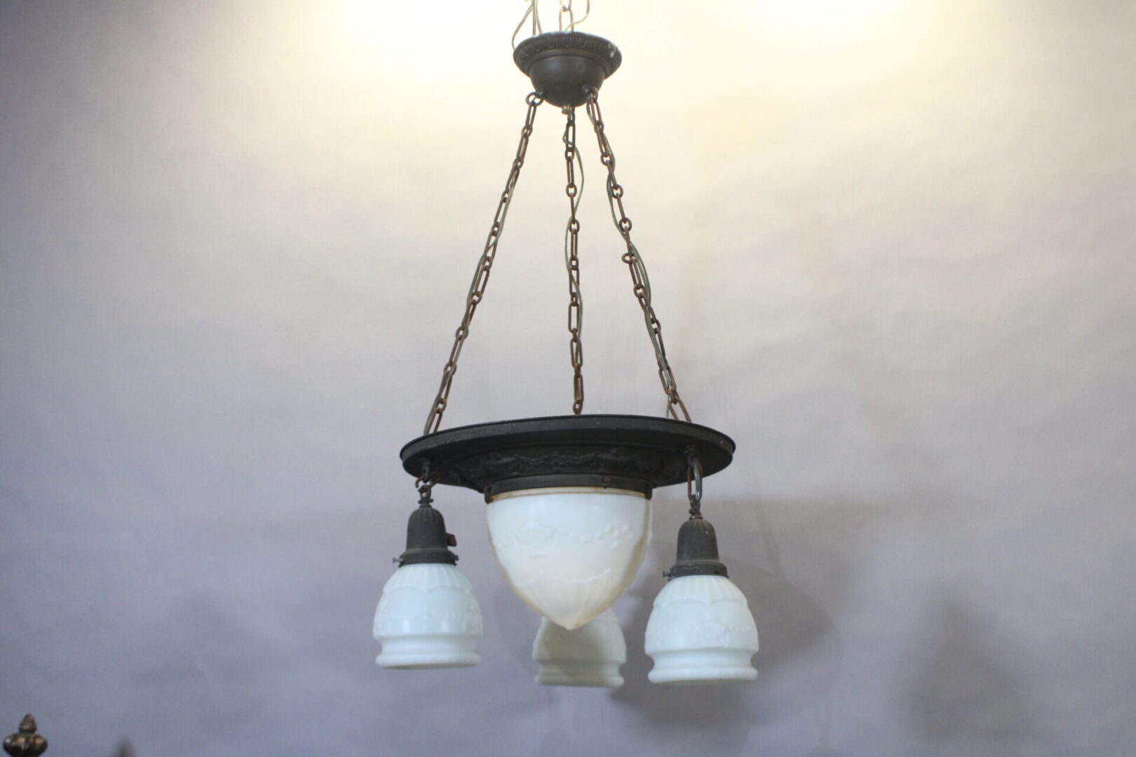 Vintage chandelier with white glass shades.