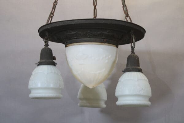 Vintage hanging light fixture with glass shades.