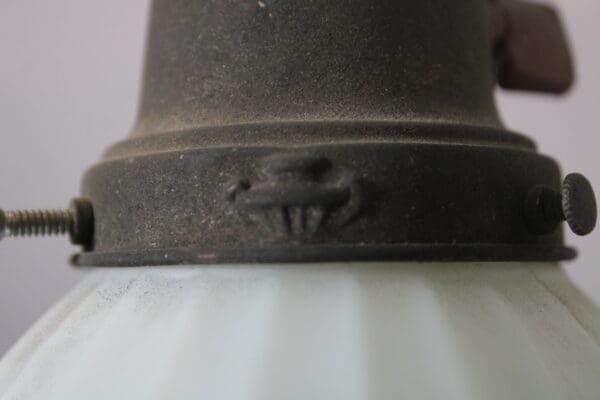 Rustic metal fixture with screws and bolts.