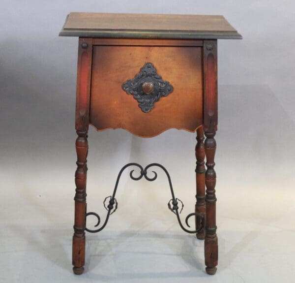 Ornate wooden side table with decorative metal accents.