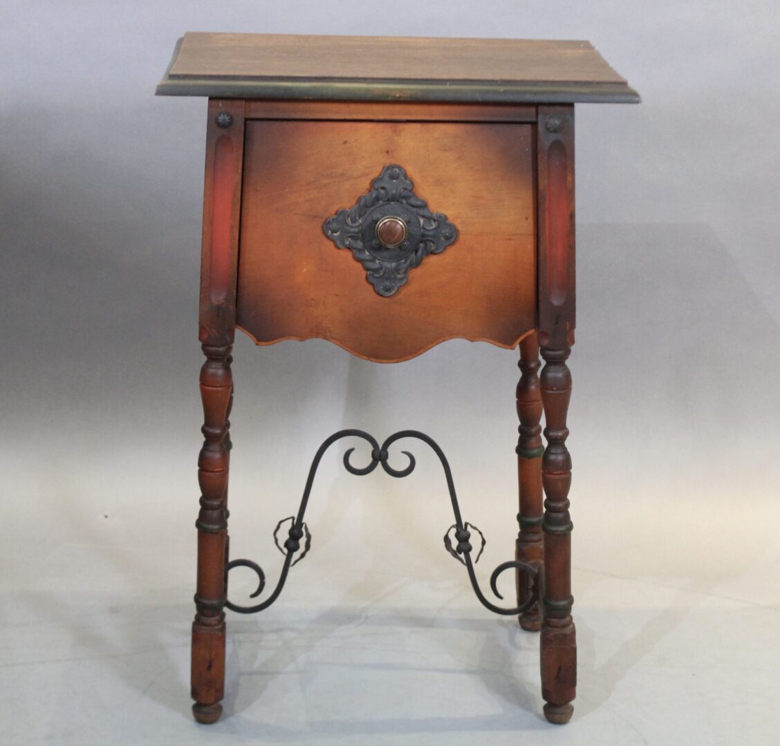 Ornate wooden side table with decorative metal accents.