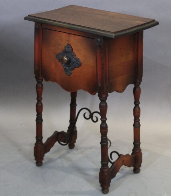 Antique wooden side table with ornate details.
