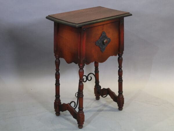 Vintage wooden side table with ornate legs.