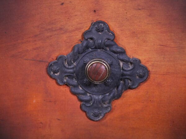 Ornate wooden furniture detail with metal accent.