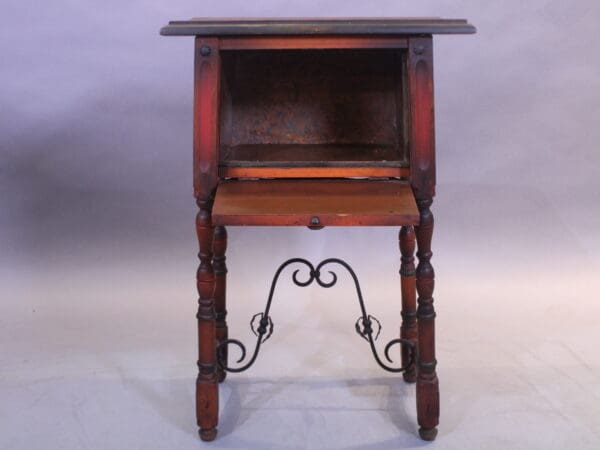 Antique wooden side table with ornate legs.