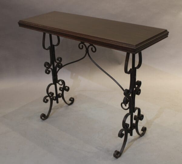 Decorative console table with wrought iron legs.