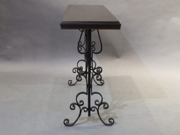 Ornate table with wrought iron legs.