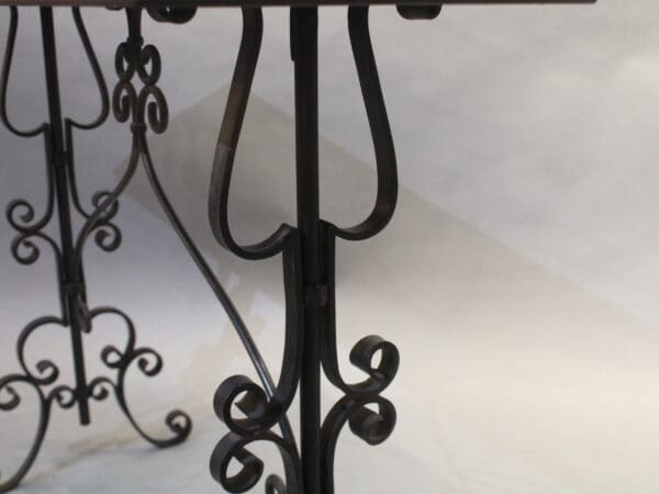Ornate wrought iron table legs and base.