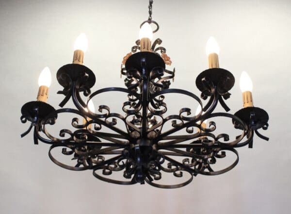 Black wrought iron chandelier with six lights.