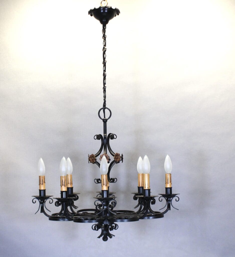 Elegant black wrought iron chandelier hanging.