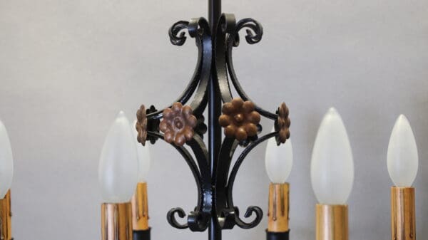 Ornate chandelier with frosted light bulbs.