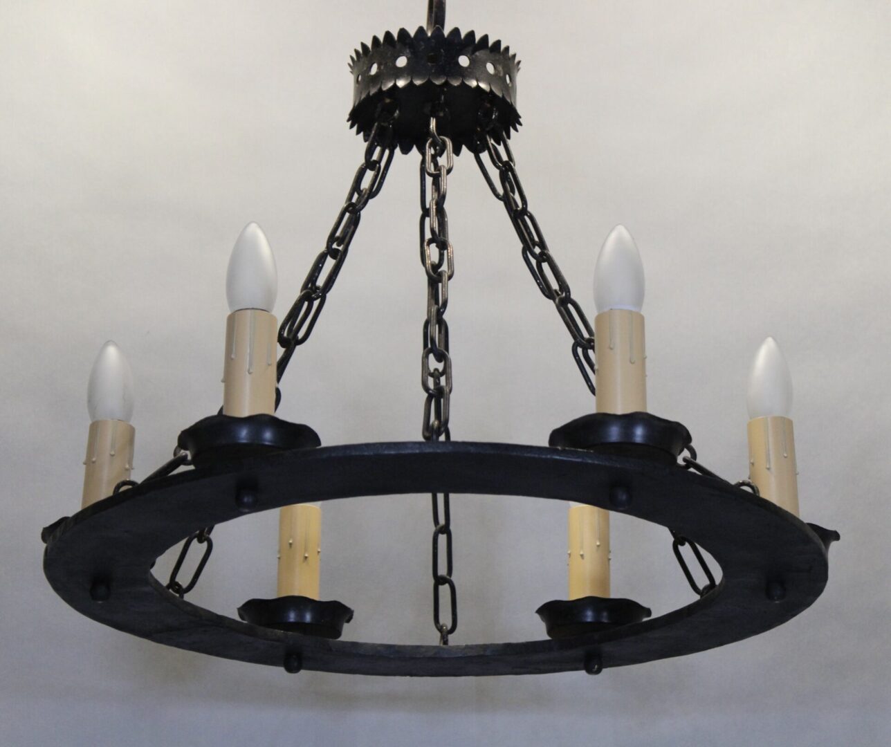 Rustic chandelier with candle-shaped bulbs.