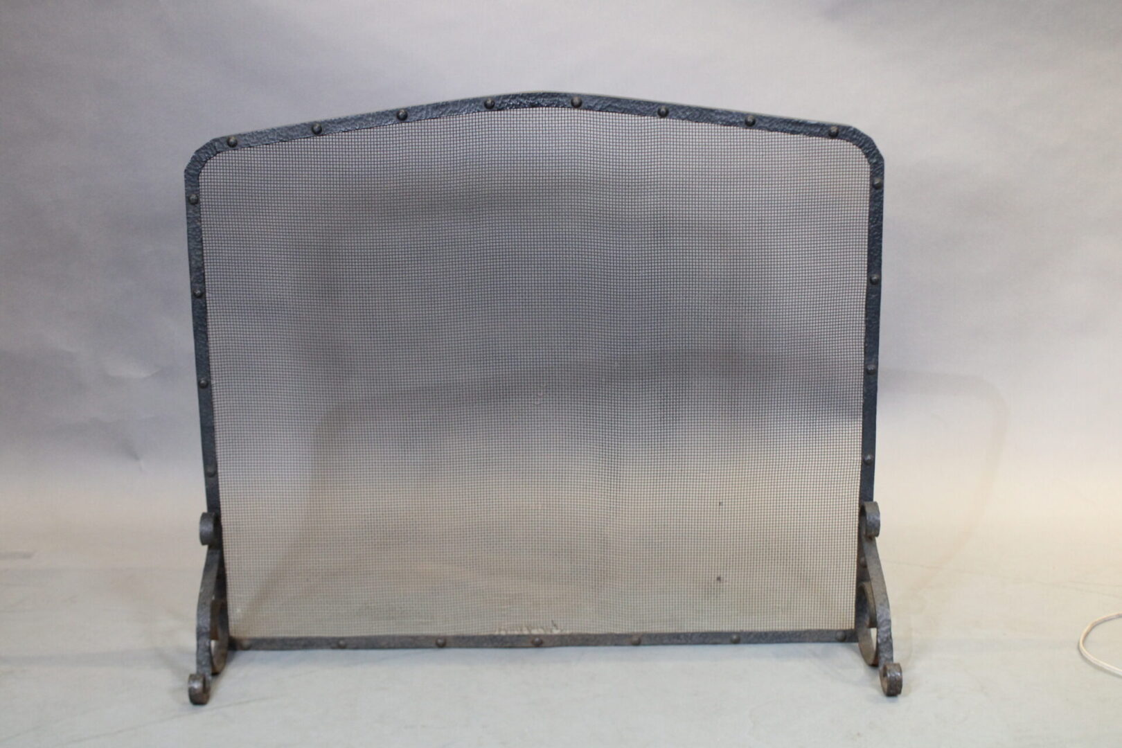 Metal mesh fireplace screen with stand.