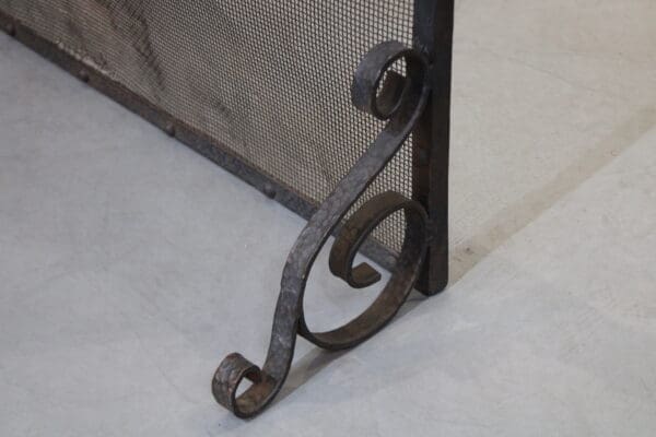 Decorative metal fireplace screen on the floor.