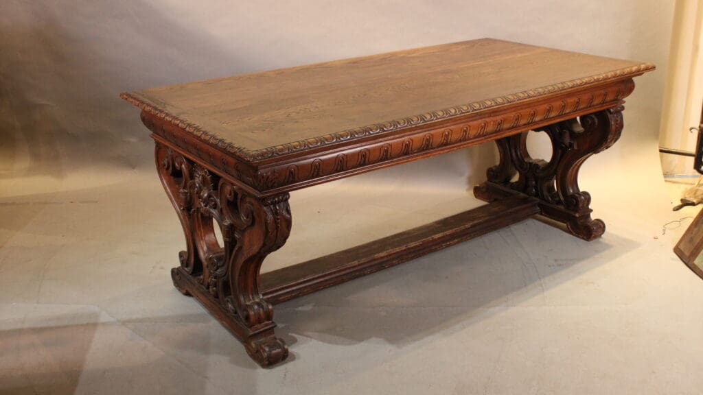 Antique wooden table with ornate carvings.