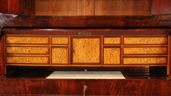 Wooden cabinet with multiple drawers and cupboard.