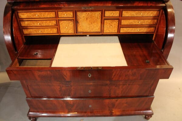 Antique wooden writing desk with drawers open.