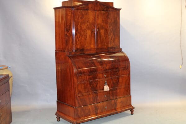 Antique wooden roll-top desk with cabinet.