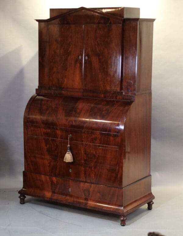 Antique wooden cabinet with roll-top desk.