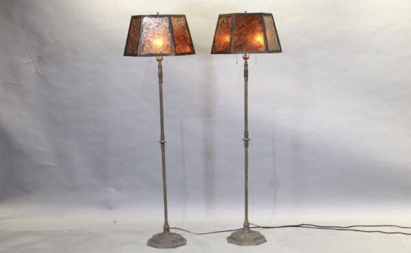Two tall floor lamps with square shades.