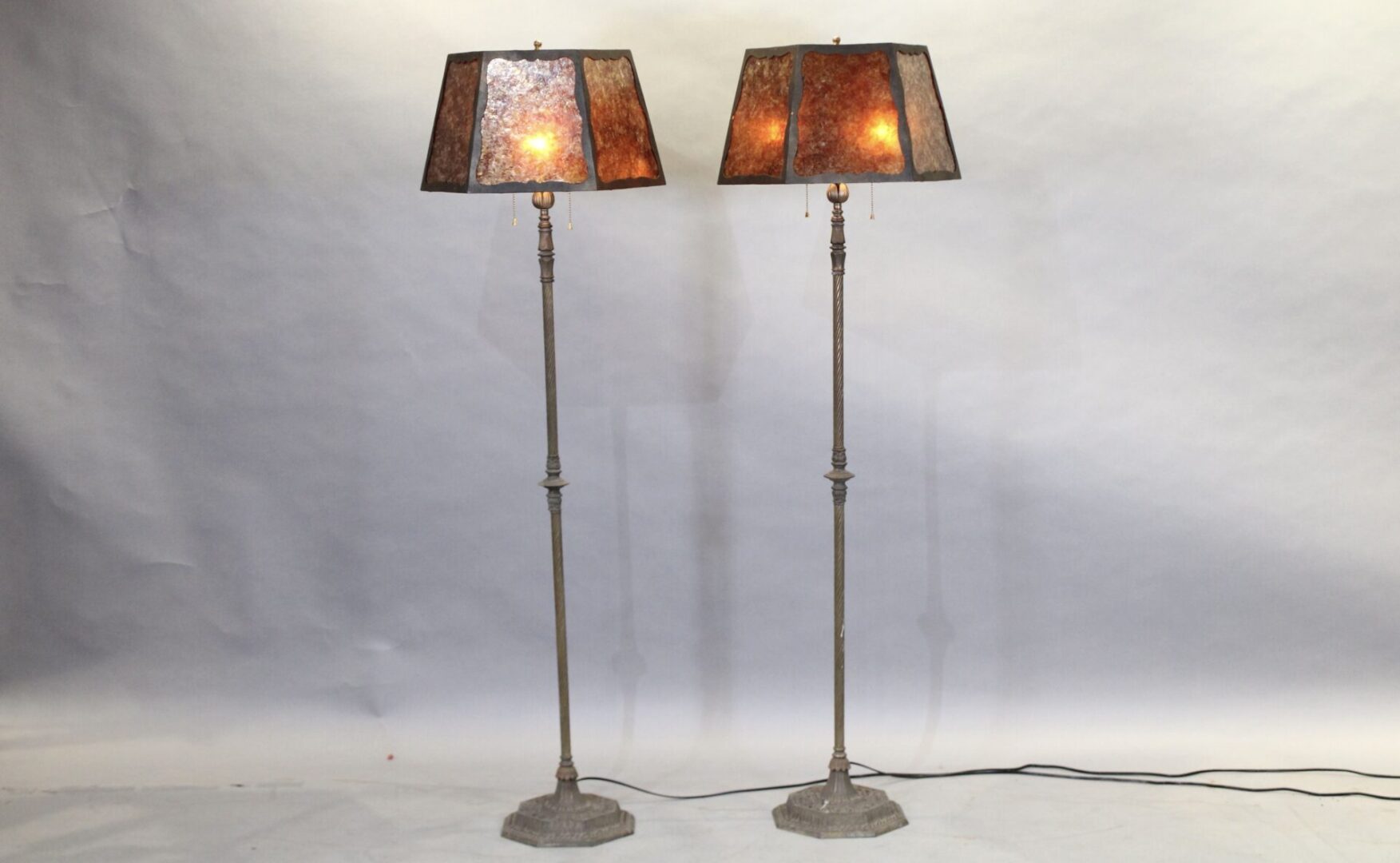 Two tall floor lamps with square shades.