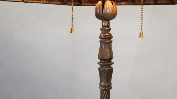 Ornate lamp stand with pull chains.