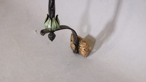 Ornate metal bracket with floral design.