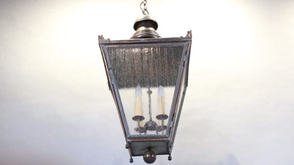 Hanging vintage lantern with glass panels.