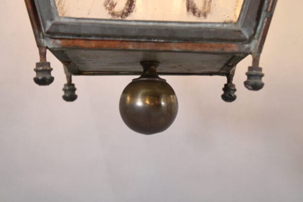 Antique lamp base with brass sphere detail.