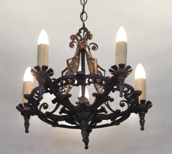 Ornate vintage chandelier with glowing candles.
