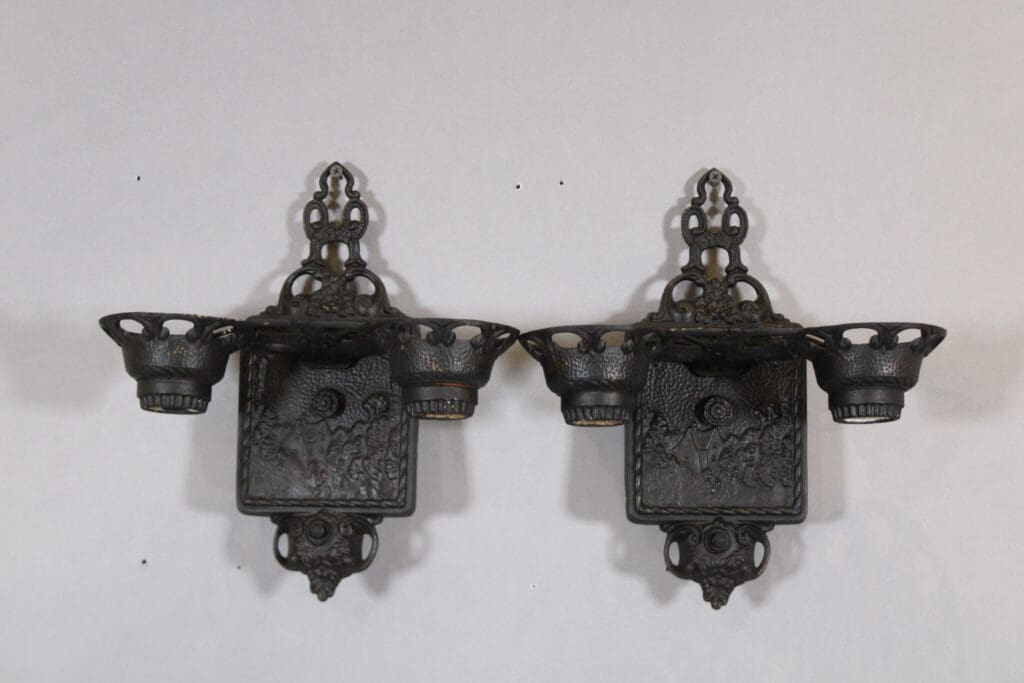 Two ornate black metal wall sconces.