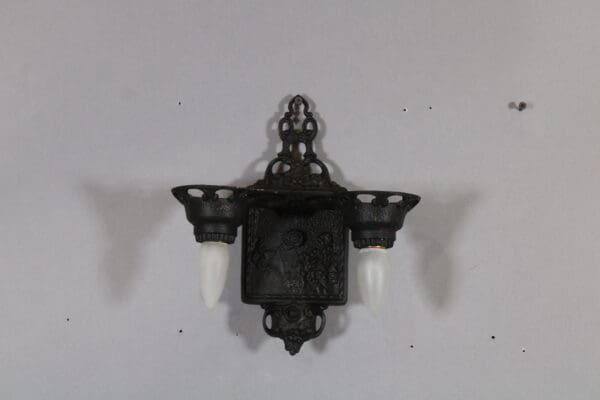 Vintage ornate two-light wall sconce fixture.