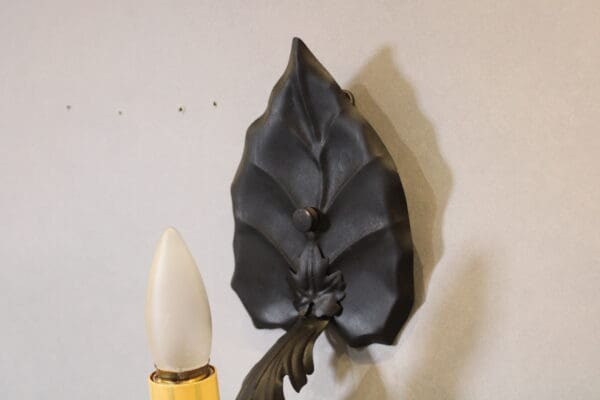 Decorative wall sconce with leaf design.