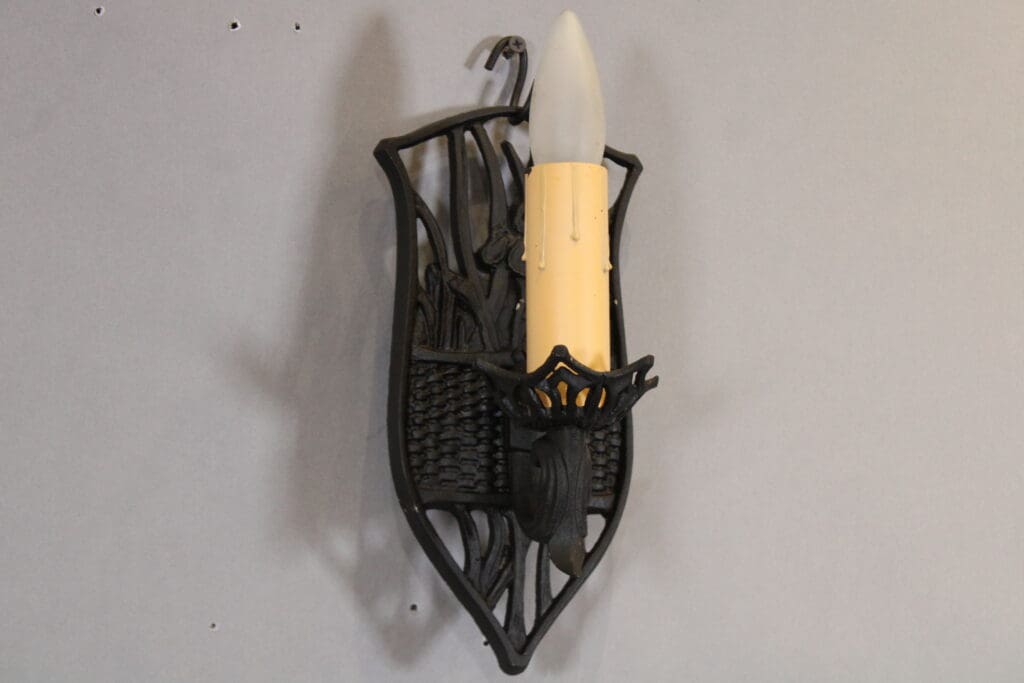 Vintage wall sconce with candle-shaped bulb.