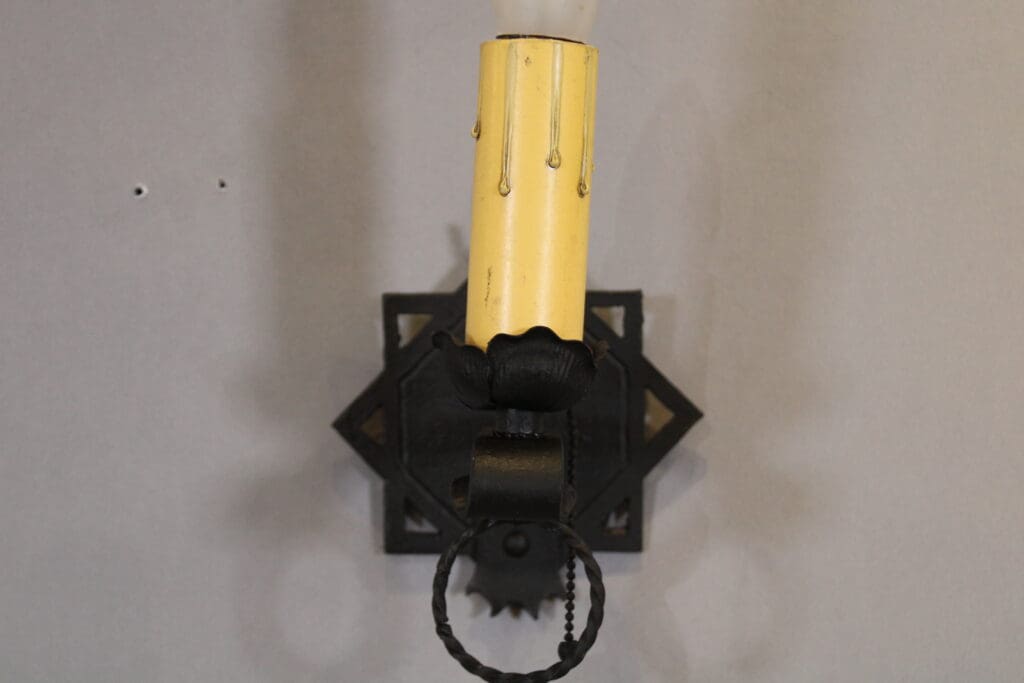 Wall-mounted vintage candle holder fixture.