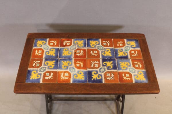 Colorful tiled wooden table with intricate patterns.