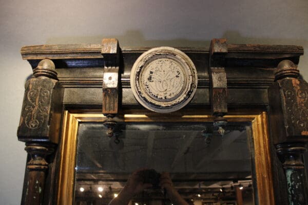 Ornate wooden mirror frame with circular design.