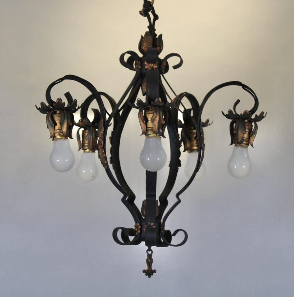 Ornate vintage chandelier with exposed bulbs.
